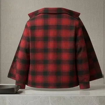 Red and black plaid jacket displayed on mannequin against gray wall with marble counter