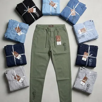 Eight folded men's trousers in various colors arranged around a single olive green pair with brand tags