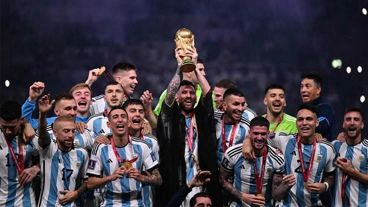 Argentina soccer team holding World Cup trophy celebrating victory with fans