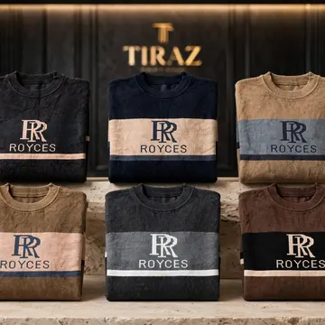 Six folded Royces brand sweaters with logo stripes arranged on a stone pedestal in a luxury retail setting
