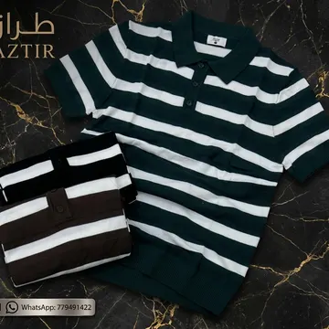 Two folded striped polo shirts on dark gold marble surface