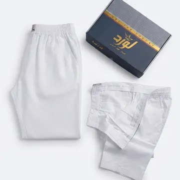 Two folded white lounge pants with branded packaging on a clean white background