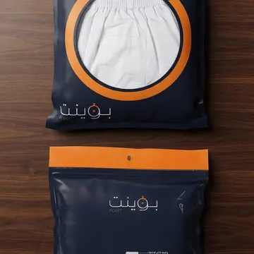 Two navy blue underwear packaging bags with orange details on a wooden table