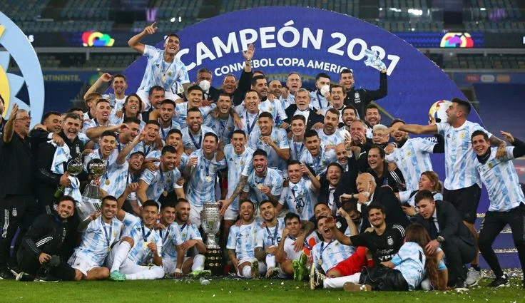 Argentina football team celebrates Copa America 2021 victory with trophy and confetti on field