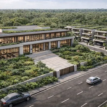 Modern buildings with green roofs and gardens beside a road with cars near a forest