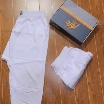 White underwear and a branded box on a wooden floor