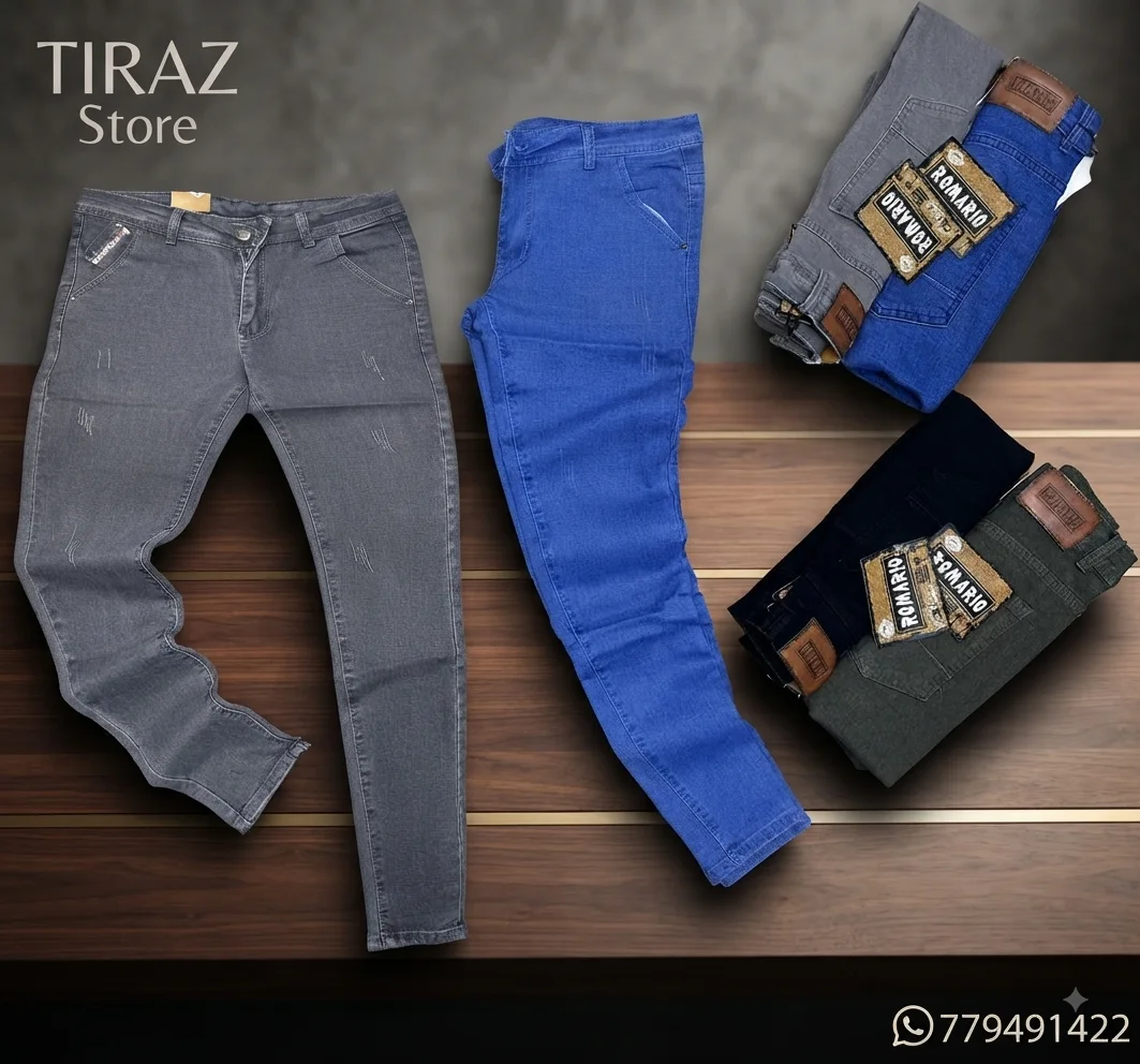 Four pairs of men's jeans in gray blue black and olive green displayed on a wooden surface