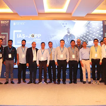 Group of men in business attire posing for a photo at a conference event