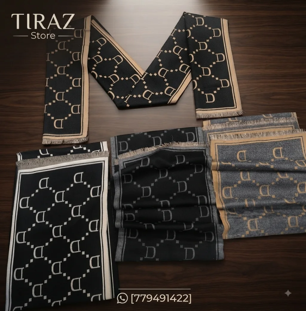Four folded scarves with D letter pattern on wooden table