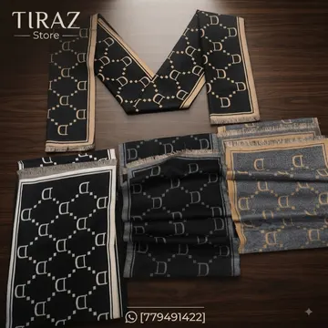 Four folded scarves with D letter pattern on wooden table