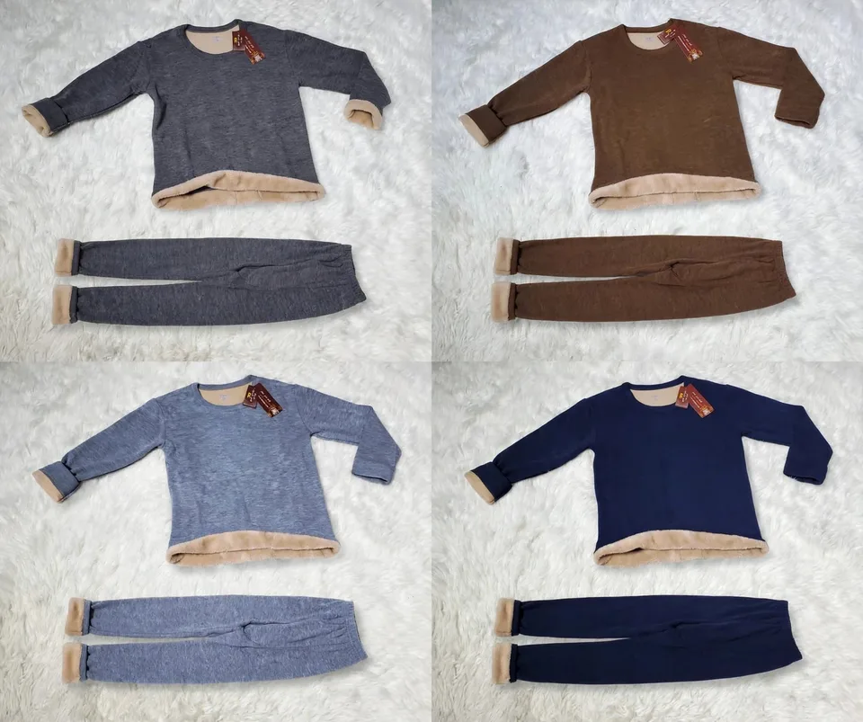 Four fleece pajama sets in gray brown blue and navy on a fluffy white rug