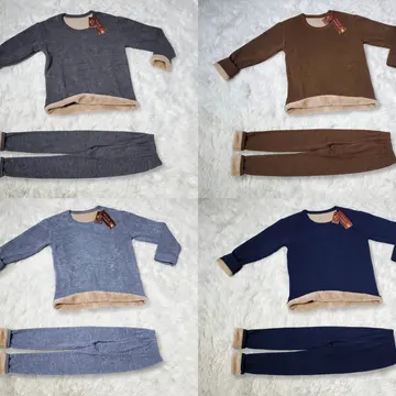Four fleece pajama sets in gray brown blue and navy on a fluffy white rug