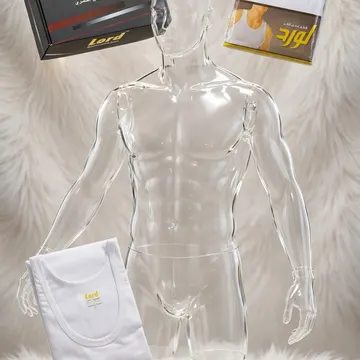 Clear mannequin with white undershirts and branded packaging on fluffy white surface with gold store plaque